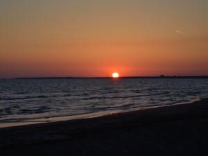 immagini di tramonto sul mare su Il sole si appoggia alla terra in un tramonto rilassato a Latina, tramonto immagini, foto tramonto, foto al tramonto